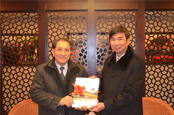梁宏校长向校友代表团赠送礼品